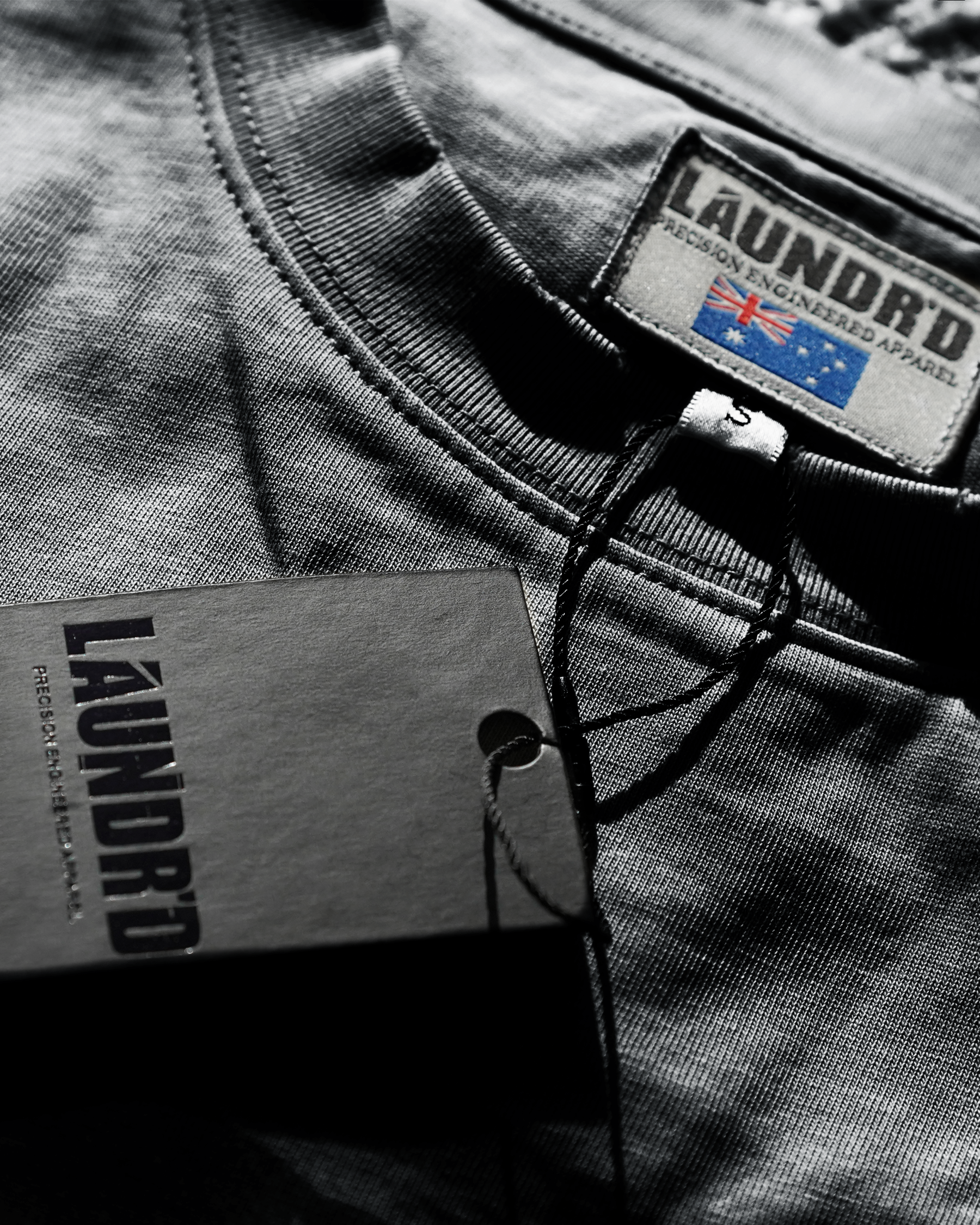 Gray t-shirt with 'LAUNDRO' branding on a plain background